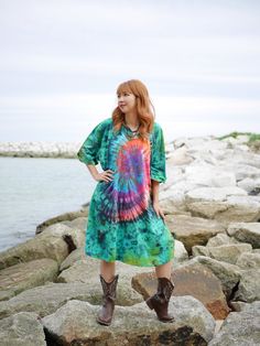 *This item is ready to ship in 2-3 weeks. Elevate your wardrobe with our stunning hand-dyed tie-dye dress, a perfect blend of vibrant hues and comfortable design. This dress showcases a vibrant, hand-dyed tie-dye dress featuring a striking combination of colors and patterns. Material and Fit: Made from 100% cotton, this tee dress/shirt dress is designed for ultimate comfort and breathability. The oversized fit is versatile and accommodating, fitting busts up to 54". With a length of 34", it can be worn as a dress or paired with leggings or jeans for a more casual look. Care Instructions: For ease of maintenance, the dress is machine washable and can be tumble dried. However, to preserve the vibrant colors and softness of the fabric, we recommend hand washing initially. Whether you're loung Hand Dyed Hippie Festival Dress, Hippie Hand Dyed Festival Dress, Flowy Hand-dyed Tie Dye Dresses, Flowy Hand-dyed Tie-dye Dresses, Flowy Tie-dye Dress, Tie Dye Festival Dress With Natural Dye, Hippie Hand Dyed Dresses For Spring, Hand Dyed Multicolor Dresses For Festival, Hand Dyed Multicolor Dress For Festival