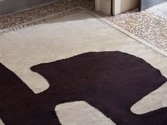 an elephant rug is on the floor next to a door