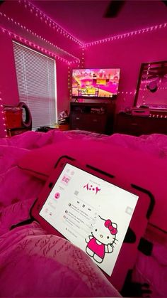 a hello kitty bed in a pink bedroom with lights on the walls and a television