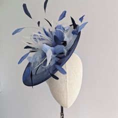 THIS ONE IS MADE TO ORDER IN YOUR CHOICE OF COLORS ☀ Follow this link for more beautiful choices from 'Indigo Hats'  https://www.etsy.com/shop/IndigoHats ☀ SCARLET - Special Occasion Hat with blue feathers. Showstopping feathers in various shades of blue adorn this unusual hat.   I made the base in a mid blue sinamay straw and added navy  crinoline around the edge  for a contemporary touch. A perfect piece to bring a couple of colors together to match your outfit! Main disc measures 12" x 13" Please contact me if you have any questions, I am always here to help:) Jaine ☀ Find your perfect fascinator here from 'Indigo Hats' https://www.etsy.com/shop/IndigoHats ☀ Thank you for considering one of my headpieces for your special occasion!     Each one is meticulously handmade - and I loved maki Unusual Hat, Unusual Hats, Special Occasion Hats, Hat With Feather, Feather Flowers, Formal Hat, Afternoon Tea Party, Blue Feathers, Dusky Blue