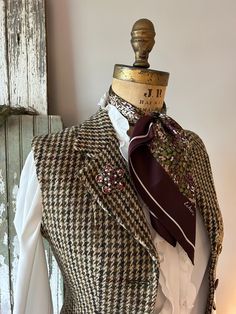 "A fitted, wool tweed vest for your winter wardrobe. This was once a houndstooth blazer and now has been altered into a vest/waistcoat. It is a 1970's Harris Tweed. I was delighted to come across this.  Wear this to dress up or down, it doesn't matter. It's one of a kind, altered by me, into a timeless piece that's a little bit more versatile than the blazer jacket it once was.  - Vintage by Civity Clothes, using a Harris Tweed. Probably 1980's or '90's. Made in England. - 100% wool tweed. - The Luxury Houndstooth Tweed Jacket For Tailoring, Luxury Vintage Fitted Tweed Jacket, Luxury Wool Tweed Workwear Dress, Luxury Gucci Tweed Jacket For Fall, Luxury Tweed Outerwear With Houndstooth Pattern, Luxury Houndstooth Tweed Jacket For Spring, Luxury Brown Houndstooth Blazer, Luxury Retro Tweed Jacket For Workwear, Winter Gucci Tweed Jacket