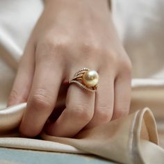 This gorgeous 18K gold pearl ring is mounted with a beautiful 12mm AAA quality golden south sea pearl with 'Very High' luster (please see our pearl grading section for more information). This beautiful pearl ring includes .52 carats of SI-quality diamonds and is made of 5.78 grams of the highest quality 18K gold. All pearl rings are approved by our staff of GIA pearl experts and come packaged in a beautiful pearl jewelry box. Please view the options below to customize your pearl ring to your spe Luxury Gold Pearl Ring For Wedding, Elegant Luxury Pearl Ring With Round Band, Luxury Pearl Drop Ring For Formal Occasions, Luxury Gold Rings With Pearl Drop, Elegant Pear-shaped Pearl Ring For Formal Occasions, Elegant Wedding Rings With Pearl Pendant, Elegant Formal Pear-shaped Pearl Ring, Luxury Gold Pearl Ring With High Luster, Luxury Akoya Pearl Ring In Pearl White