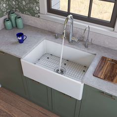 a kitchen sink with a cutting board on the counter