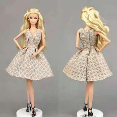 two barbie dolls wearing dresses and high heels