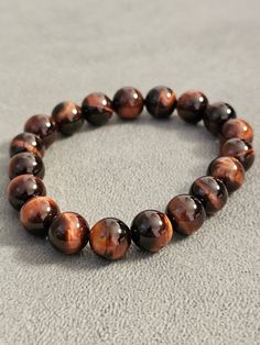 Tiger Eye Bracelet 8mm beads Handmade Quality materials that will last a long time Shade of deep brown Gif for him Gift for her 8mm Beads, Tiger Eye Bracelet, Eye Bracelet, Beads Handmade, Deep Brown, Tiger Eye, Cross Pendant, Glass Beads, Jewelry Bracelets