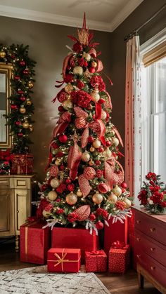 a christmas tree decorated with red and gold ornaments