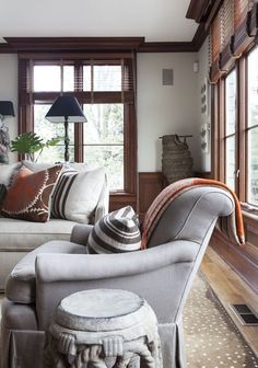 a living room filled with furniture and lots of windows