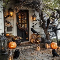 halloween decorations with pumpkins and jack - o'- lanterns on the front porch