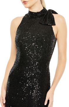 Get your glow on with a sequin-showered gown, done in a close fit and accented with a bow detail gracing a single shoulder. 62 1/2" length Halter neck Sleeveless, with cutaway shoulders Lined 100% polyester Spot clean Imported Black Tie Gowns, Evening Gowns Online, Wedding Guest Style, Column Skirt, Sheath Gown, Mac Duggal Dresses, Tie Neck Dress, Unique Prom Dresses, Sleeveless Gown