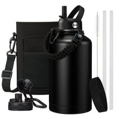 the black water bottle is next to two white drinking straws and an empty cup