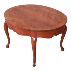 an oval wooden table with two legs