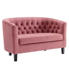 a pink couch sitting on top of a white floor