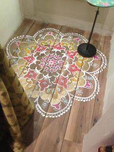 the floor is made out of wood and has an intricate design on it, as well as a black umbrella