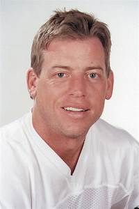 a man wearing a white uniform posing for a photo in front of a white background