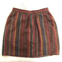 Urban Renewal Nwt Vintage Skirt Size 7/8 100% Virgin Wool One Of A Kind. Skirt Is Reworked Vintage And Recycled Pieces, Deadstock Fabric, Eco-Fabrics And One-Of-A-Kind Finds. Please See Measurements In Photographs Skirt Is Brown With Stripes Colors Of Purple Rust Maroon And Tan. The Skirt Is Fully Lined And Has A Zipper Button Closure In Back. The Skirt Is Vintage And Reworked By Urban Renewal Original Brand Name Is Patty Woodard California. Condition: Nwt Closet Item: B 45 Brown Casual Midi Skirt, Casual Brown Midi Skirt, Multicolor Skirted Bottoms For Fall, Fall Multicolor Skirt With Elastic Waistband, Multicolor Skirt With Elastic Waistband For Fall, Casual Brown Relaxed Skirt, Casual Brown Relaxed Fit Skirt, Casual Multicolor Skirt With Pockets, Relaxed Fit Brown Cotton Skirt