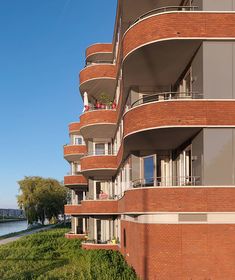 an apartment building with balconies overlooking the water