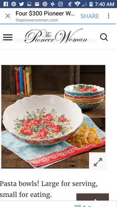 a bowl with flowers on it is sitting next to another bowl that has food in it