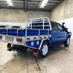 a blue pick up truck parked in a garage