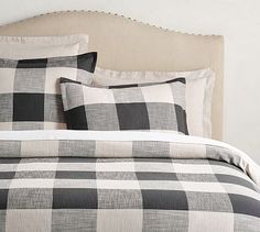 a black and white checkered comforter set on a bed with two pillow cases