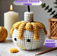 a pumpkin - themed candle holder made with crochet is shown next to some knitting needles