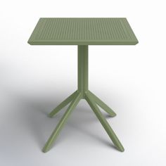 a small green table sitting on top of a white floor