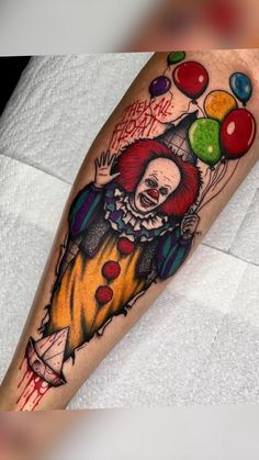 a clown tattoo on the leg with balloons