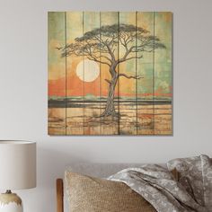 a painting on the wall above a bed with a lamp and pillows in front of it