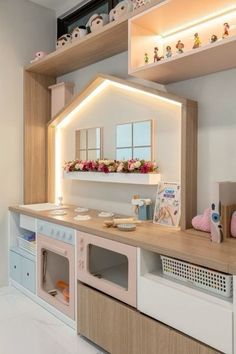 a kitchen with an oven, microwave and shelves above it that have flowers on them