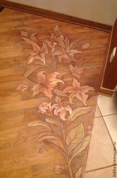 a wooden floor with flowers painted on it