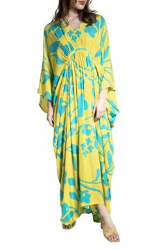 Hit the beach or kick it poolside in this flowy kaftan that features an allover floral pattern, kimono-inspired sleeves and a sharkbite hem. V-neck Kimono-inspired sleeves 100% rayon Hand wash, line dry Imported Floral Print Flowy Maxi Cover-up, Flowy Tropical Cover-up With Floral Print, Beachy Tunic Kaftan For Spring, Spring Vacation Rayon Kaftan, Spring Rayon Kaftan With Kimono Sleeves, Yellow Kaftan For Beach Cover-up, Flowy Floral Print Maxi Length Cover-up, Flowy Kaftan For Spring Vacation, Breezy Spring Kaftan