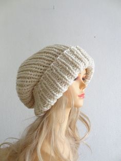 a mannequin head wearing a white knitted beanie hat with long blonde hair