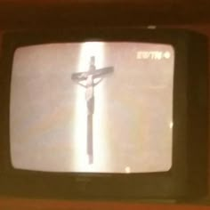 an old television with a crucifix on it