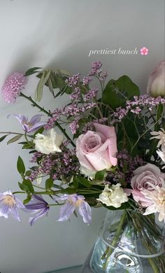 a vase filled with lots of flowers on top of a table