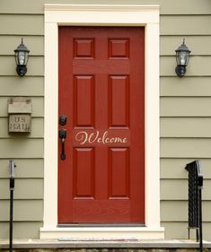 a red door with welcome written on it