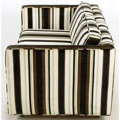 a striped couch sitting on top of a white floor