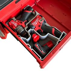 a red tool box filled with tools on top of a white surface