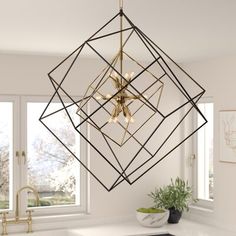 a modern chandelier hangs over a kitchen counter