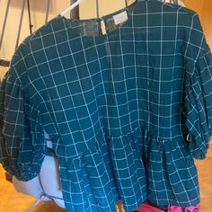 This Is A Dark Green Gingham Top. The Top Has Puff Sleeves That Are Perfect To Add Style To Any Outfit. The Top Comes In The Size Xs. This Top Is True To Size And Never Worn. Plaid Cotton Tops For Daywear, Cotton Gingham Top For Daywear, Relaxed Fit Gingham Cotton Top, Relaxed Fit Cotton Gingham Tops, Trendy Gingham Cotton Blouse, Casual Gingham Blouse For Brunch, Spring Plaid Relaxed Fit Tops, Chic Plaid Cotton Tops, Plaid Relaxed Fit Tops For Spring