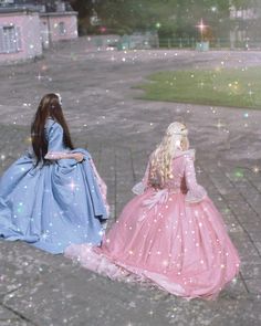 two dolls are sitting on the ground with sparkles all around them and one is wearing a pink dress