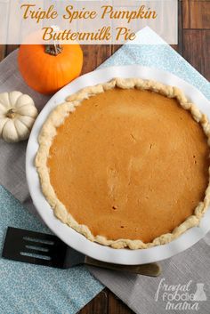 a pumpkin pie sitting on top of a white plate