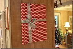 a red and white wrapped present hanging on the wall