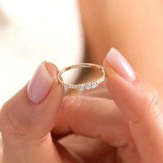 a close up of a person holding a ring