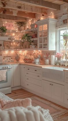 a kitchen filled with lots of white cabinets and counter top space next to a window