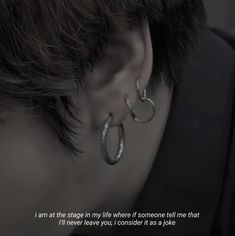 a person wearing ear rings with a quote written on the back of it that says, i am at the stage in life where if someone tell me