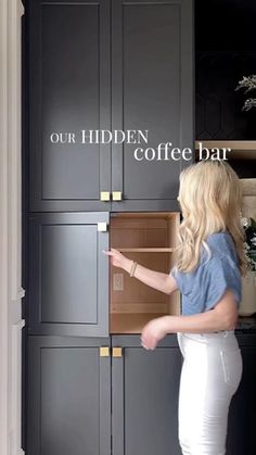 a woman opening a coffee bar cabinet with the words our hidden coffee bar on it