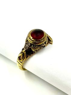 For Sale on 1stDibs - Fine, museum quality unusual early Byzantine 6th-8th Century AD amulet ring with a hidden cross. High circular flower form bezel with a domed top set with Harrow Faire, Garnet, Ring, Gold