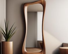 a wooden mirror sitting on top of a wall next to a potted plant