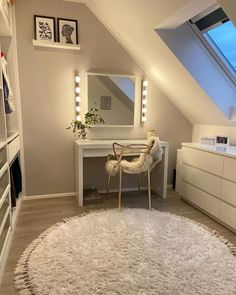 a room with a white rug and some lights on the ceiling, along with a chair