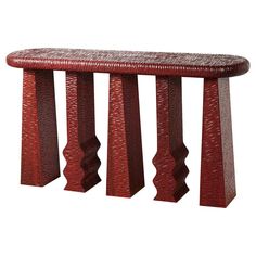 a red bench sitting on top of a wooden table