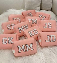 pink and white pillows with letters on them